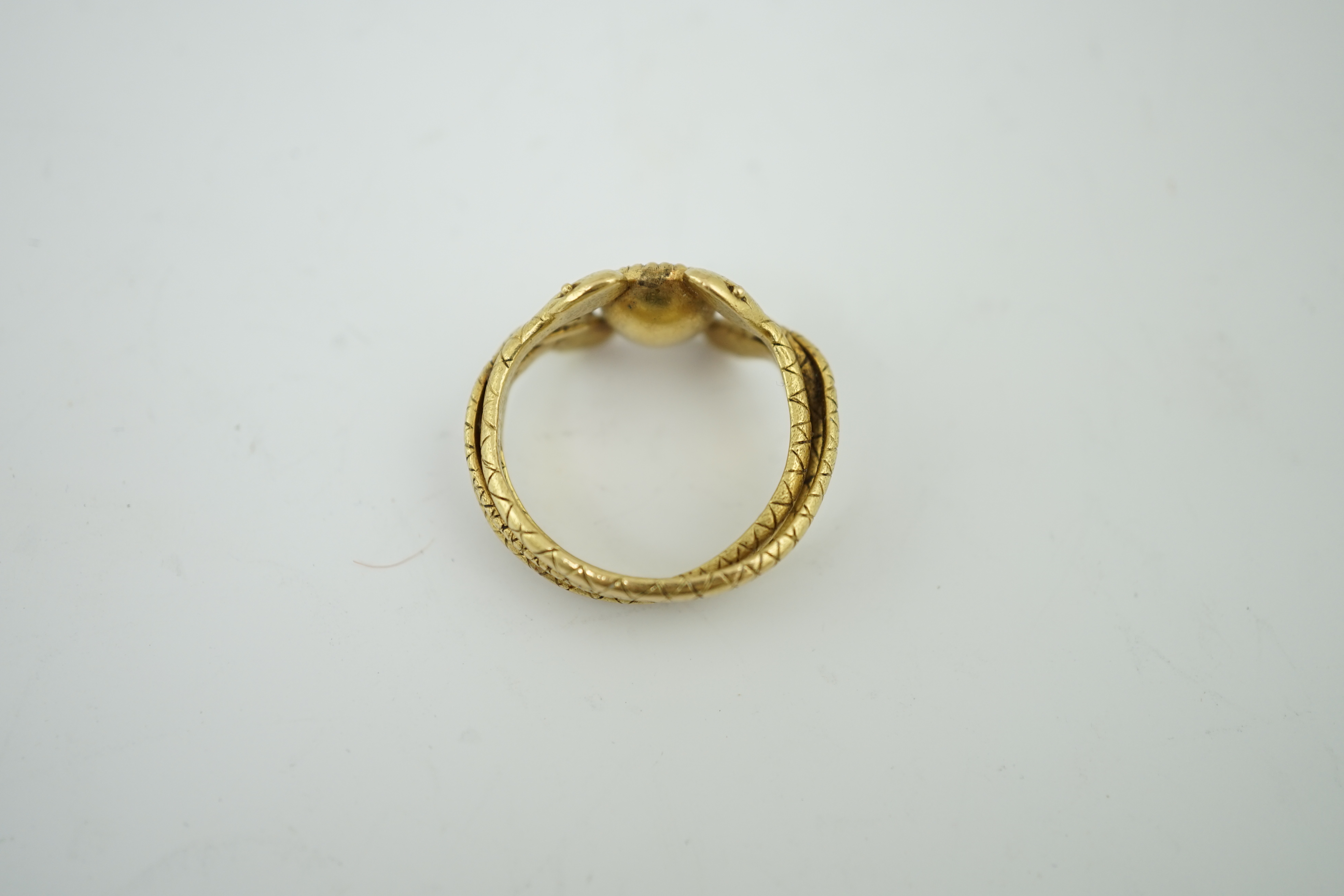 A late 19th century American Marcus & Co gold and single stone oval cut Sri Lankan sapphire set serpent ring
